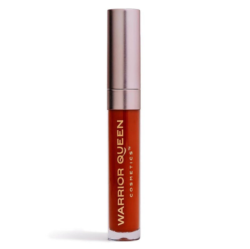 Blaze orange lip stain container labeled with gold Warrior Queen Cosmetics brand text.