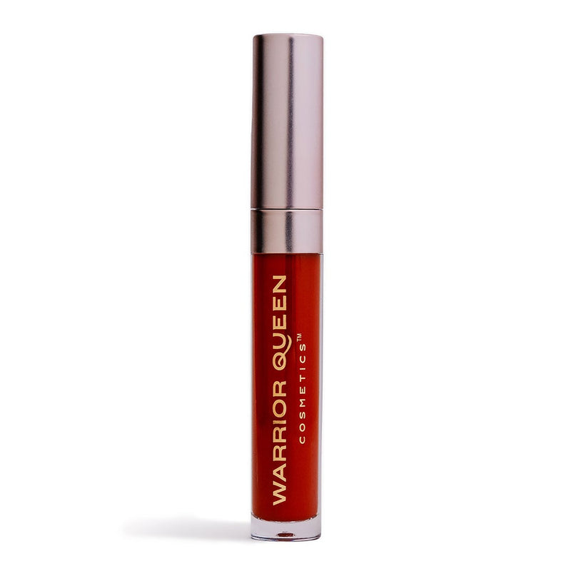 Fire red lip stain container labeled with gold Warrior Queen Cosmetics brand text.