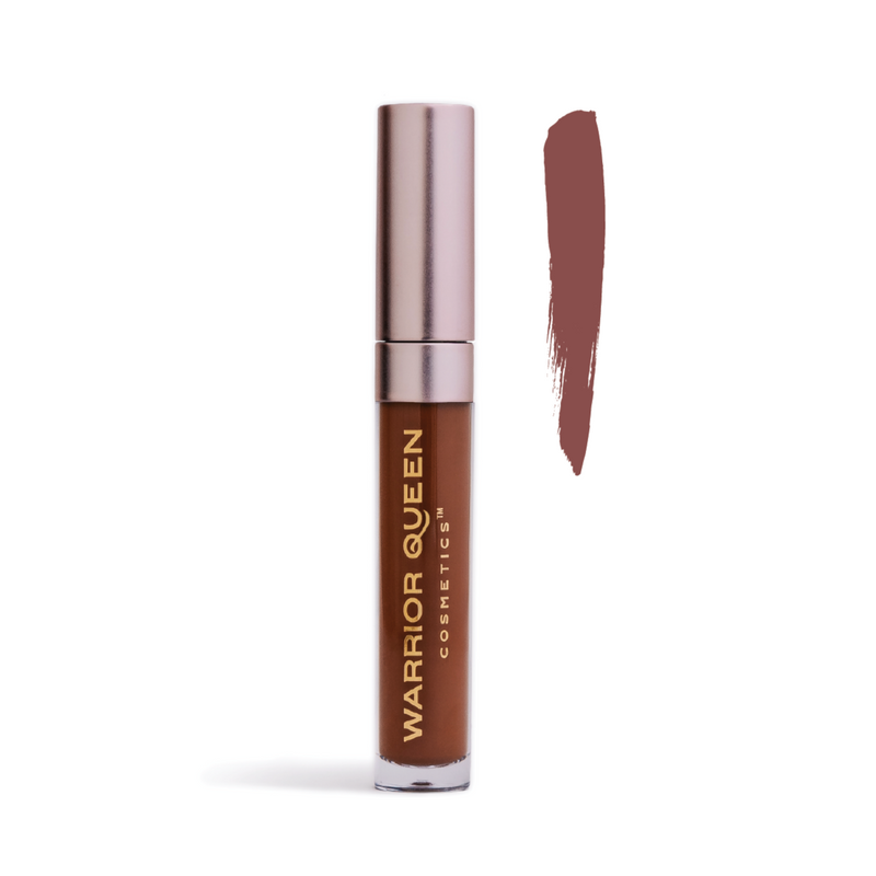 Power brown lip stain container labeled with gold Warrior Queen Cosmetics brand text and to the right of the container a vertical brush stroke of power brown color sample.