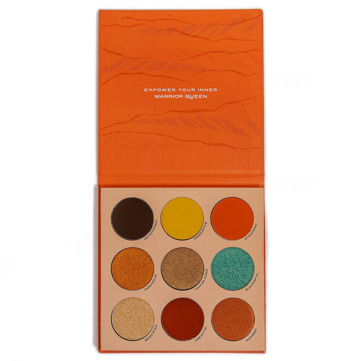 Inside view of the Trailblazer eyeshadow palette shows the phrase “empower your inner warrior queen” and it's 9 colors: Determined, innovative, strategic, ingenious, trailblazer, successful, dedicated, creative, and pioneer.